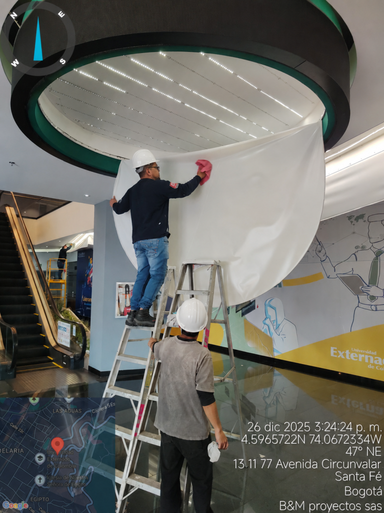 Técnicos de B&M Proyectos desmontando la membrana Tensoflex® translúcida de una luminaria circular para revisar el sistema de iluminación.